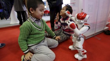 Chinese kid playing with robot
